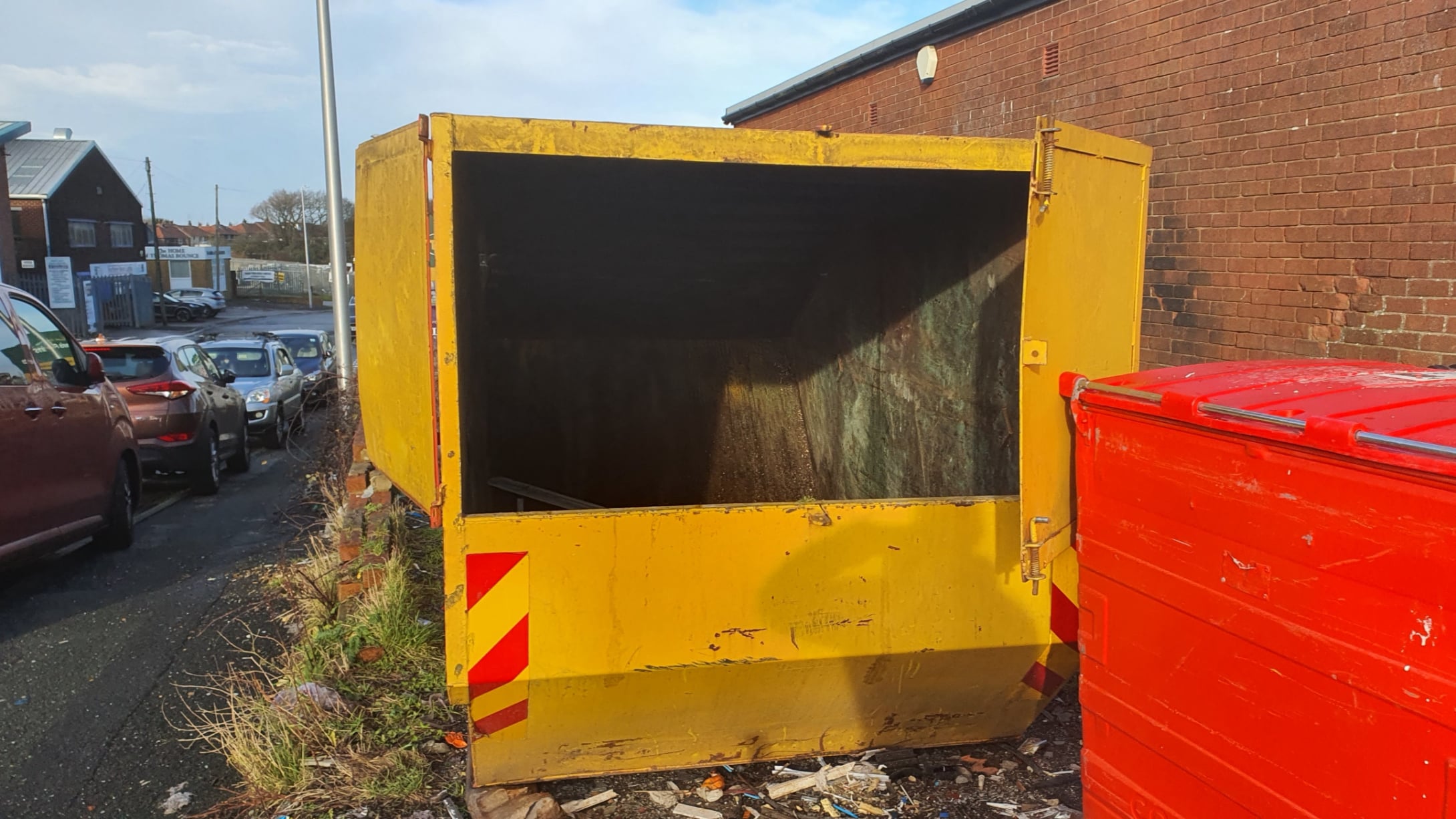 Waste double glazing placed in skip for landfill