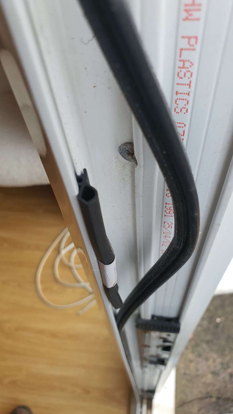    A close‑up of a uPVC door frame showing a black rubber gasket seated inside the channel. The seal runs along the edge of the frame and is designed to compress when the door closes to create a weather‑tight seal.
